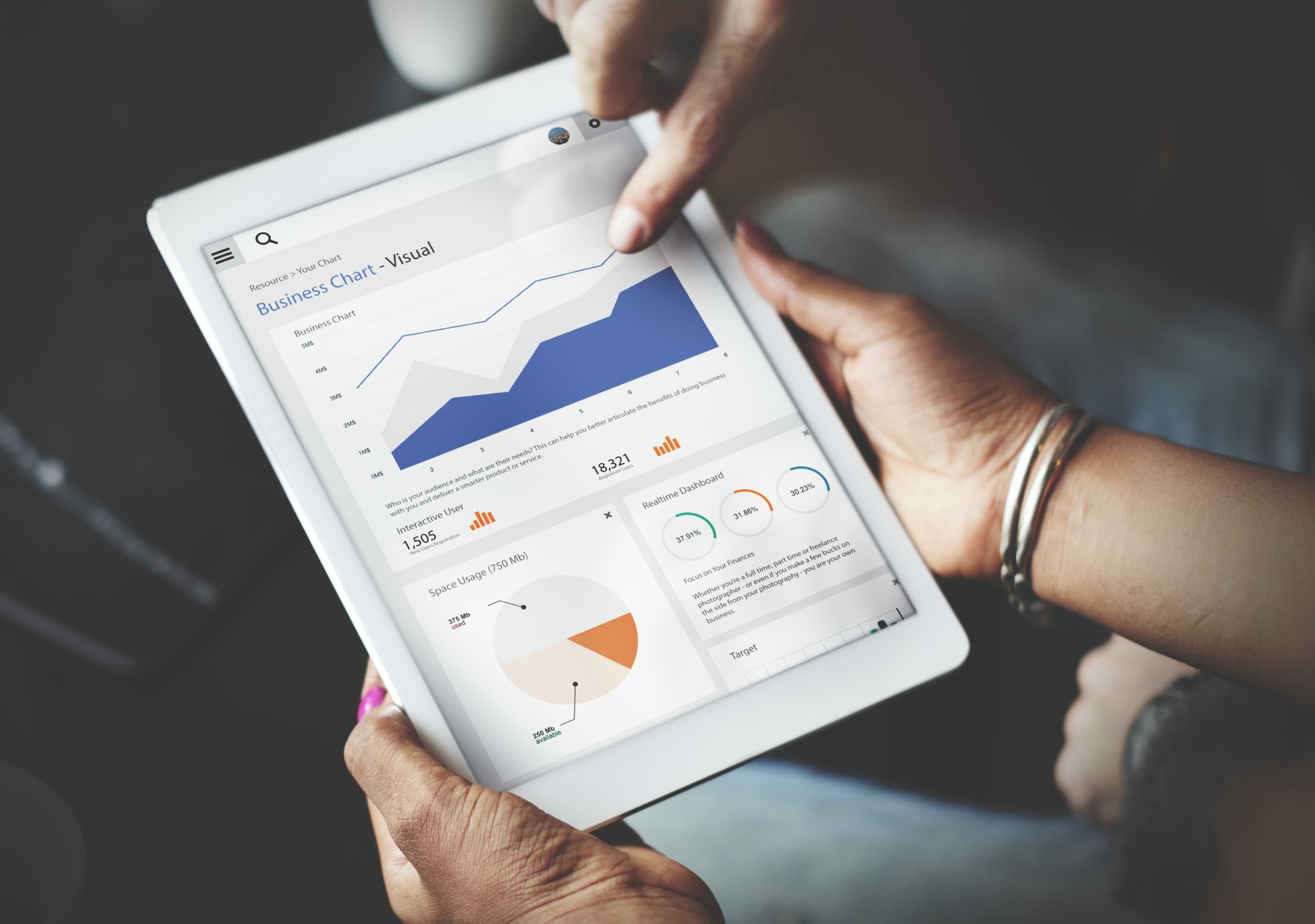 hands-using-tablet-screen-showing-statistics-business-data_53876-42762